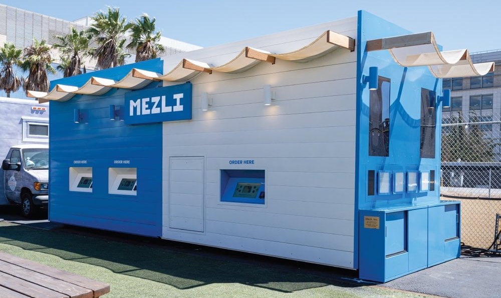 A Mezli kiosk in blue and white, with a Mediterranean feel