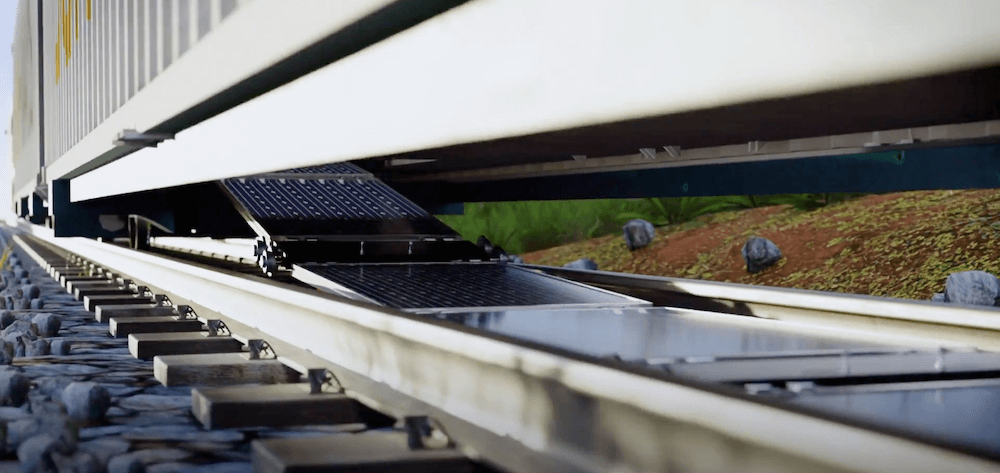 Photovoltaic panels unfurling between railroad tracks