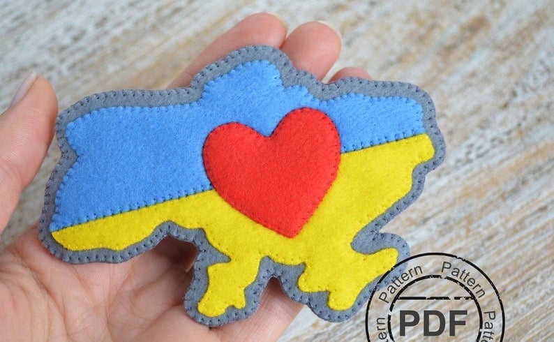 Felt brooch in the shape of Ukraine, with a heart in the middle