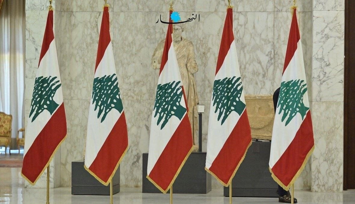 A row of five Lebanese flags in a government building 