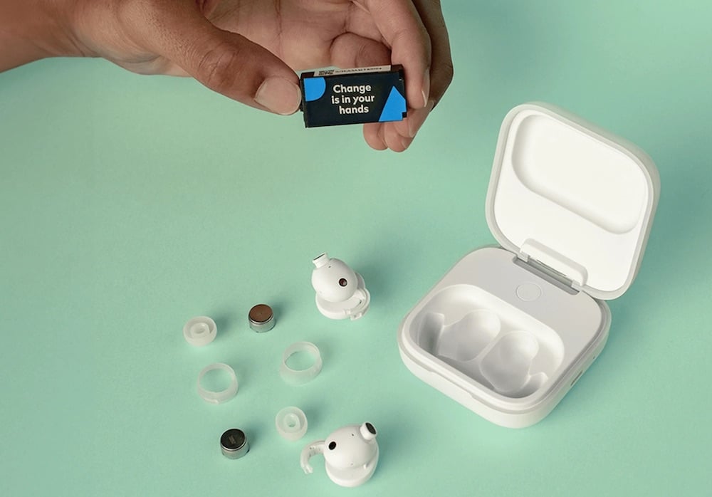 A charging case plus disassembled earbuds. Accompanying text: 'Change is in your hands'