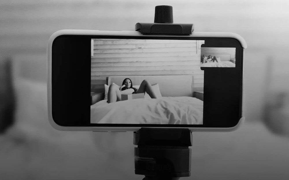 Phone on tripod, showing a woman demonstrating an at-home insemination 