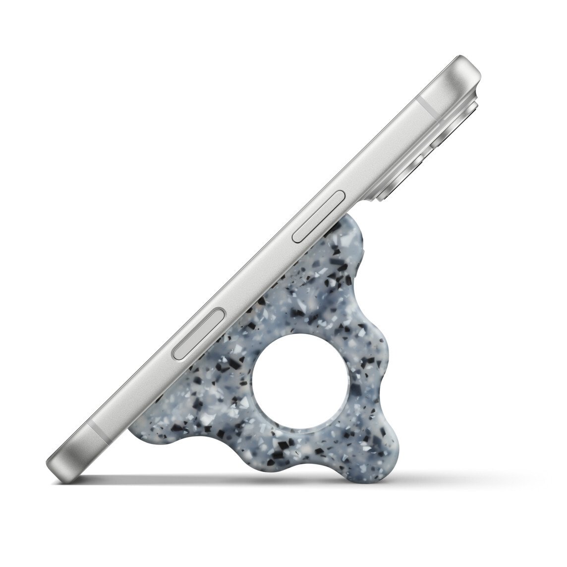Side view of a smartphone resting on a sculptural, speckled MagSafe grip that supports the device at an angle 