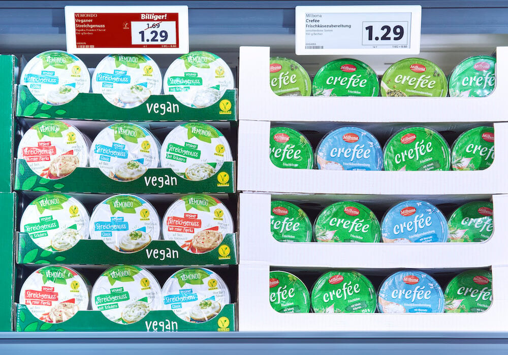 Supermarket display of cream cheese; the vegan version's price lowered to match the non-vegan kind