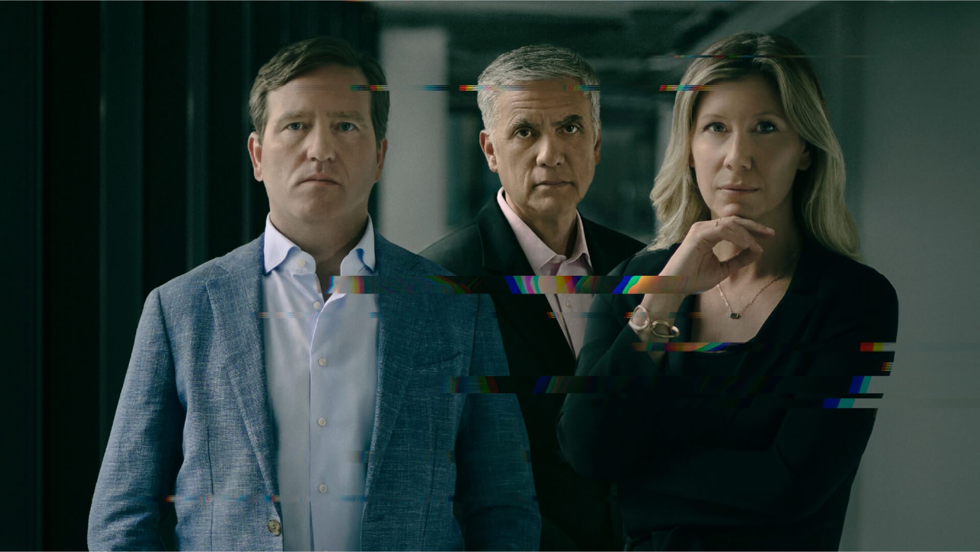 A composed portrait of three adults standing side by side in a dim corridor, looking directly at the camera, with horizontal glitch-like digital artifacts streaking across the image to suggest themes of cybersecurity and digital interference 
