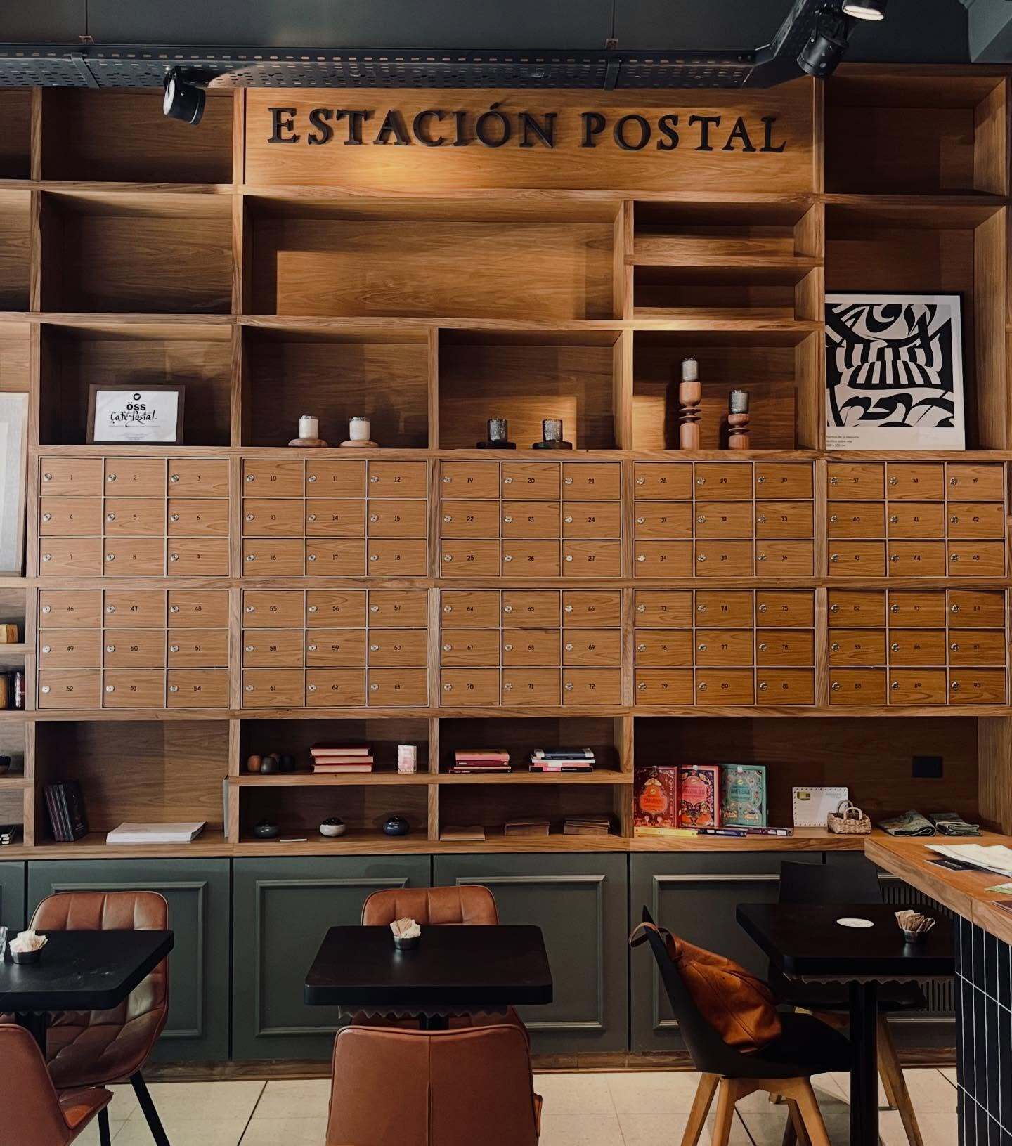 Wall of numbered wooden mailboxes labeled 