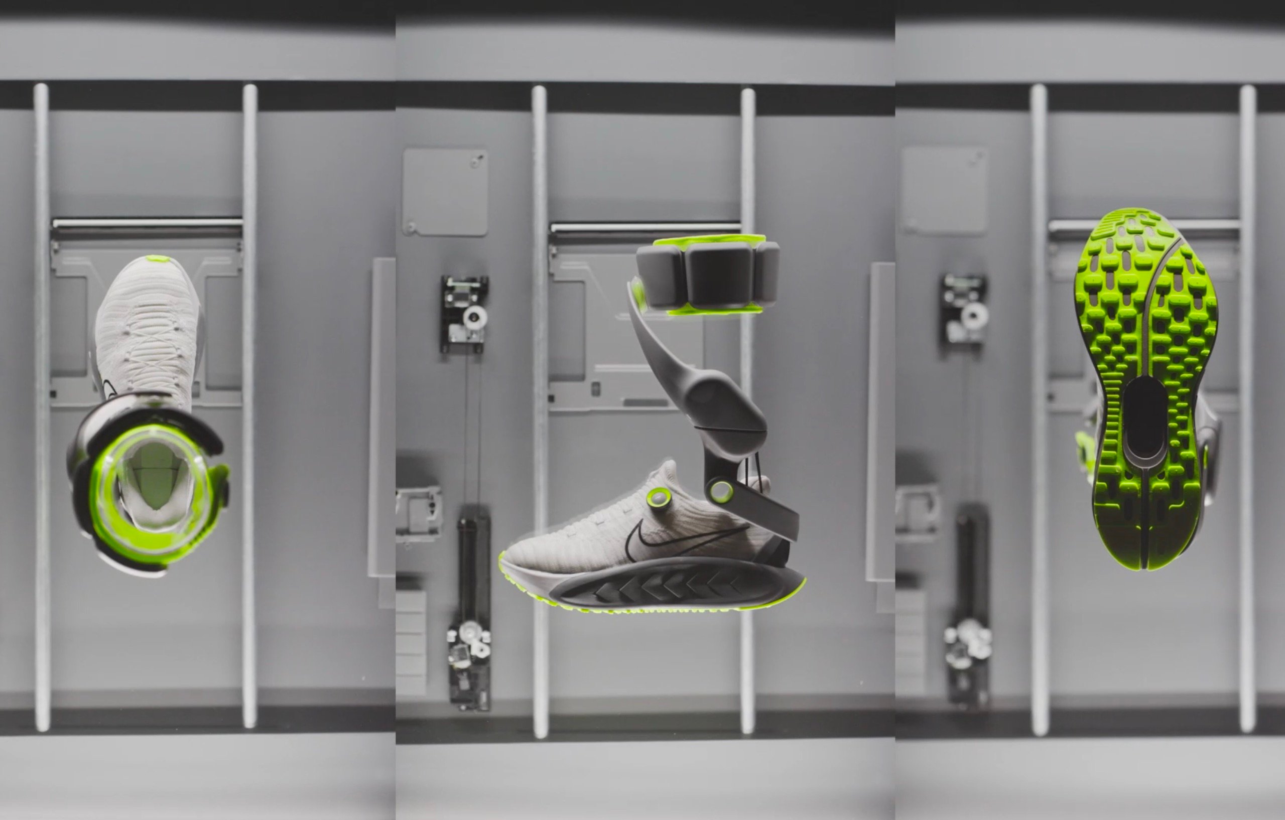 A futuristic Nike sneaker prototype suspended in a lab-like environment. The shoe features sleek white uppers with a black swoosh, neon green highlights on the sole and ankle brace, and mechanical attachment points for robotic integration 