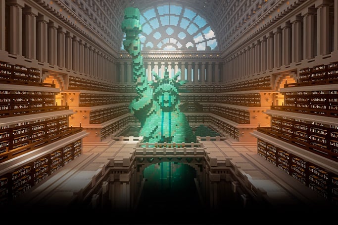 A grand hall built in Minecraft featuring a blocky green Statue of Liberty at its center, surrounded by towering walls lined with bookshelves and illuminated by warm lighting, with a large arched window behind the statue 